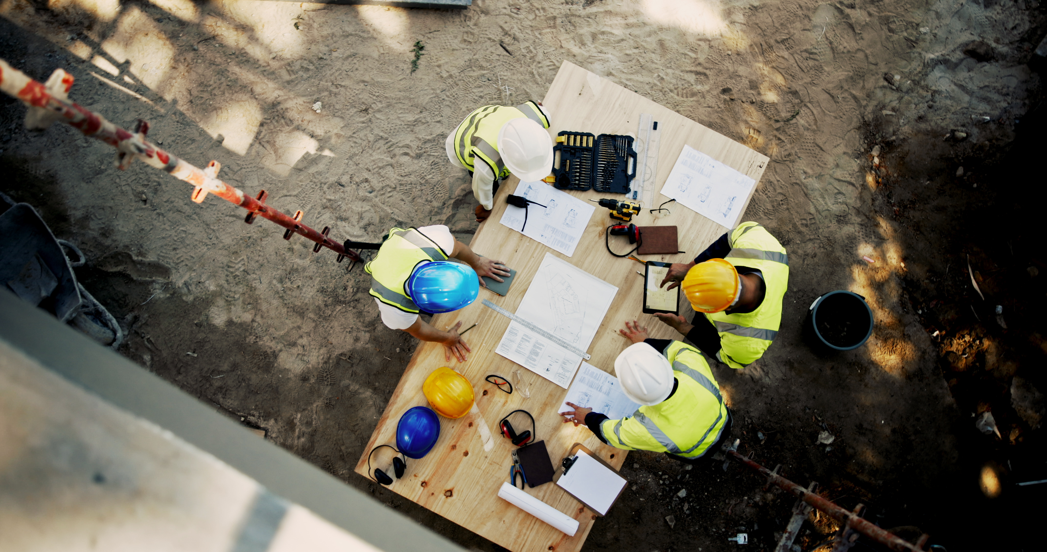 Architecture, tablet and business people with blueprint for construction site, building and planning. Above, engineer team and employees with ideas for industry renovation, infrastructure and meeting